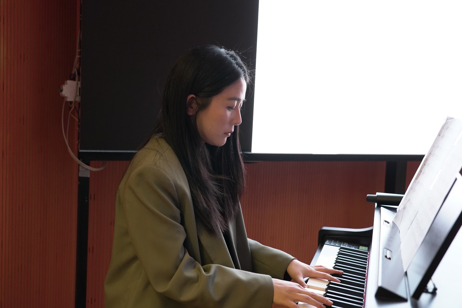 Hyojung Jung accompanying the KOSA Choir on piano